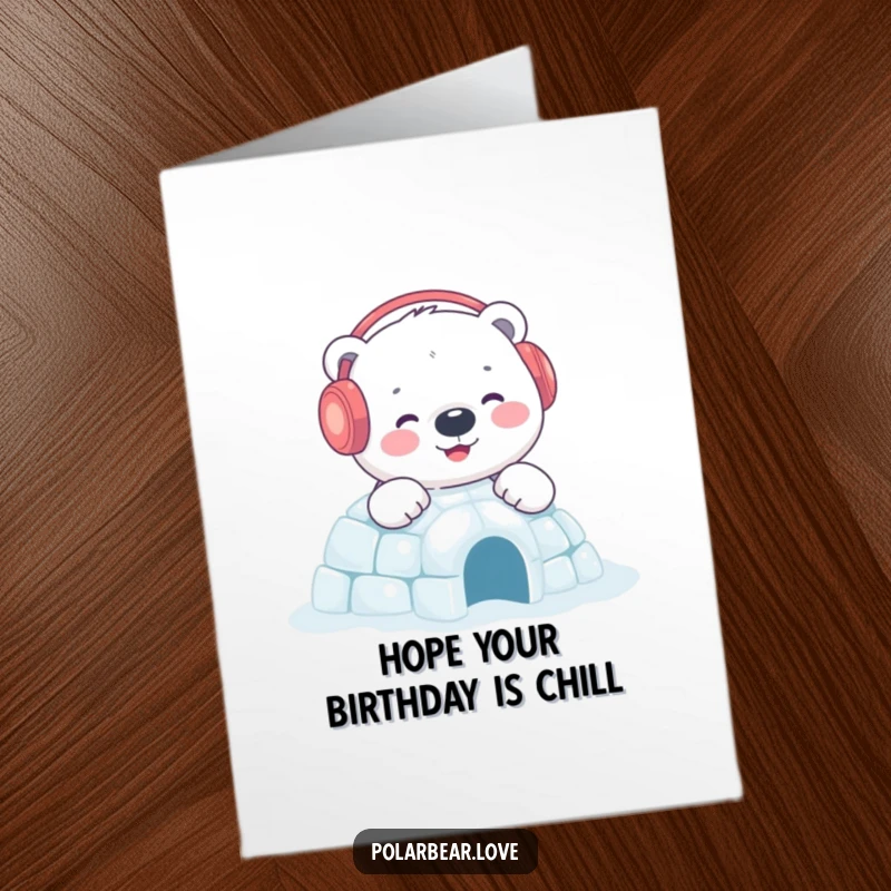 Charming Free Printable Birthday Card: Content polar bear in earmuffs happily builds a small, sparkling igloo, sending birthday cheer.
